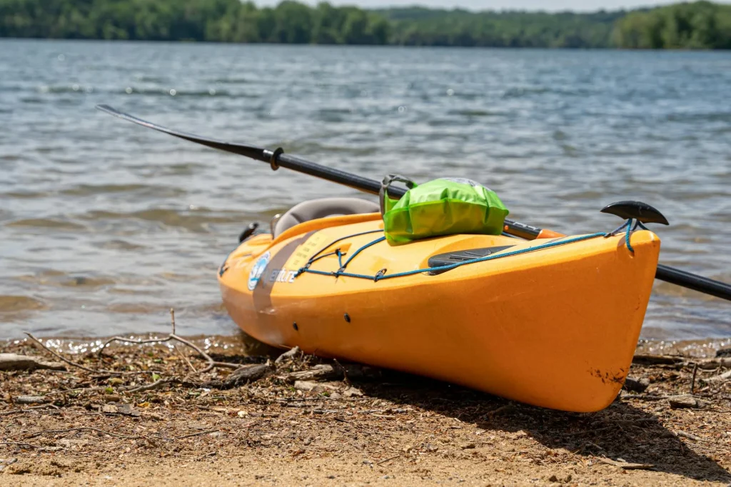 Waterproof dry bag on a kayak by a river
