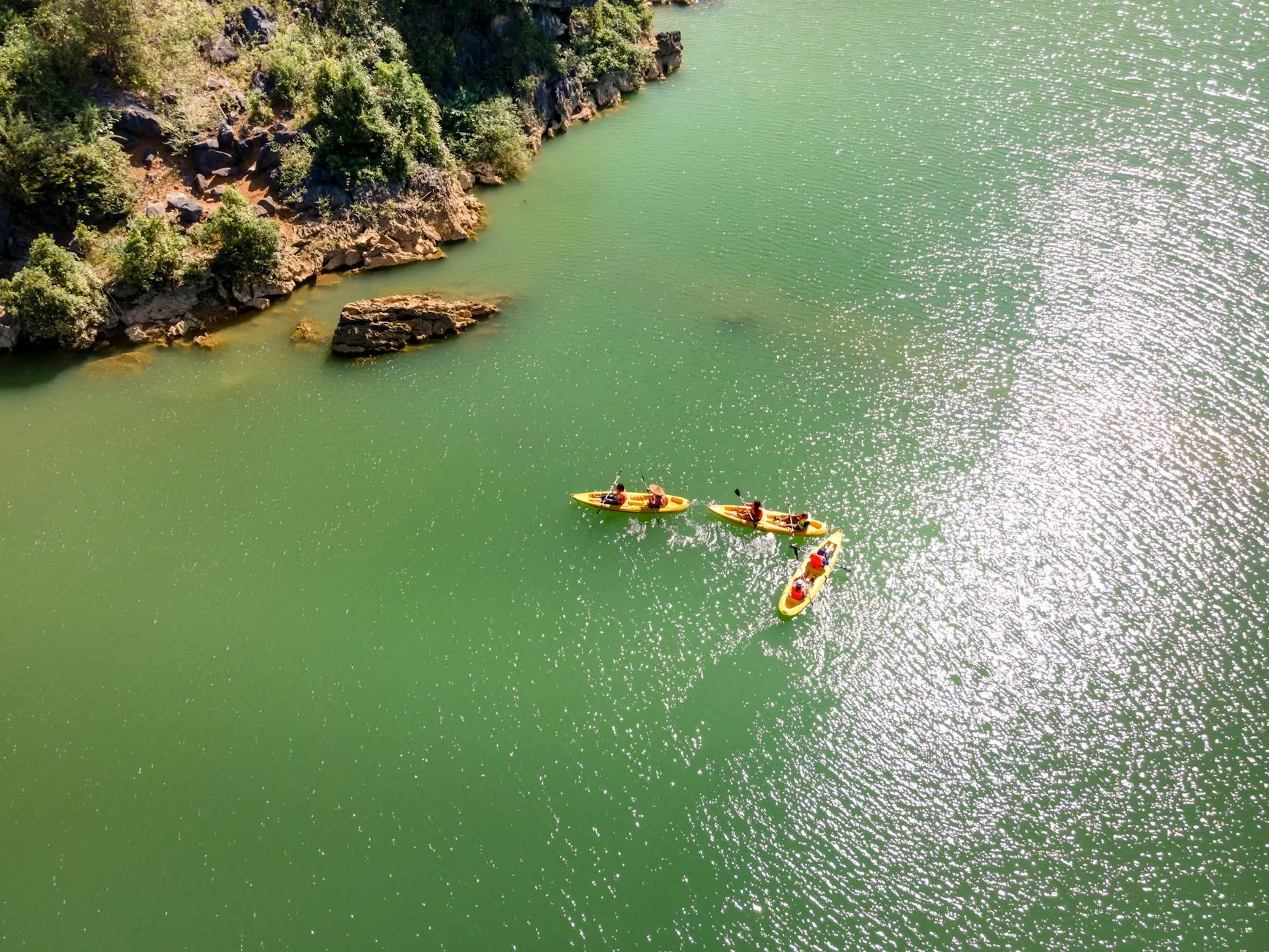 Family kayaking with children on a river in summer