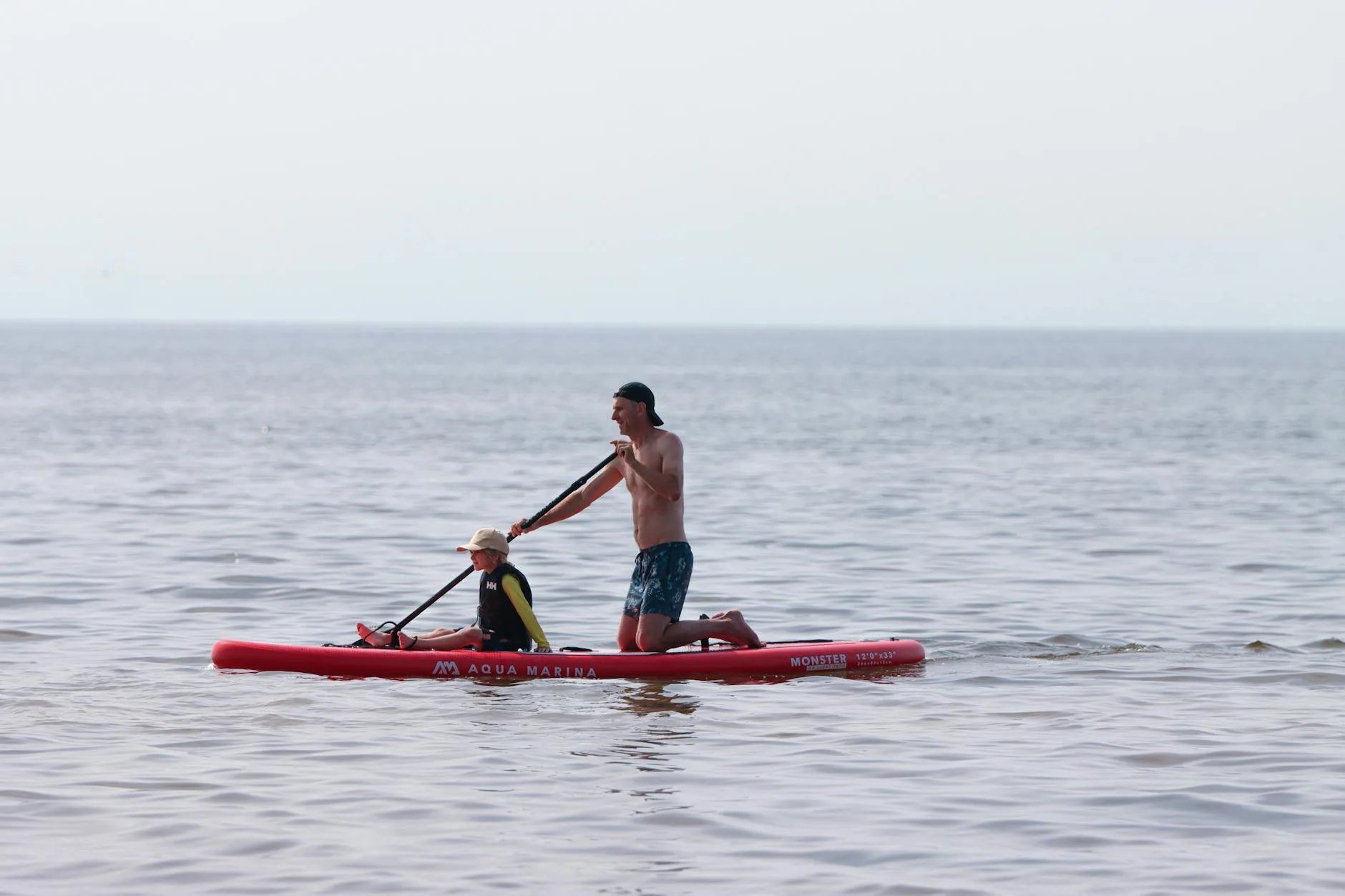 Family paddleboarding together with children on the water