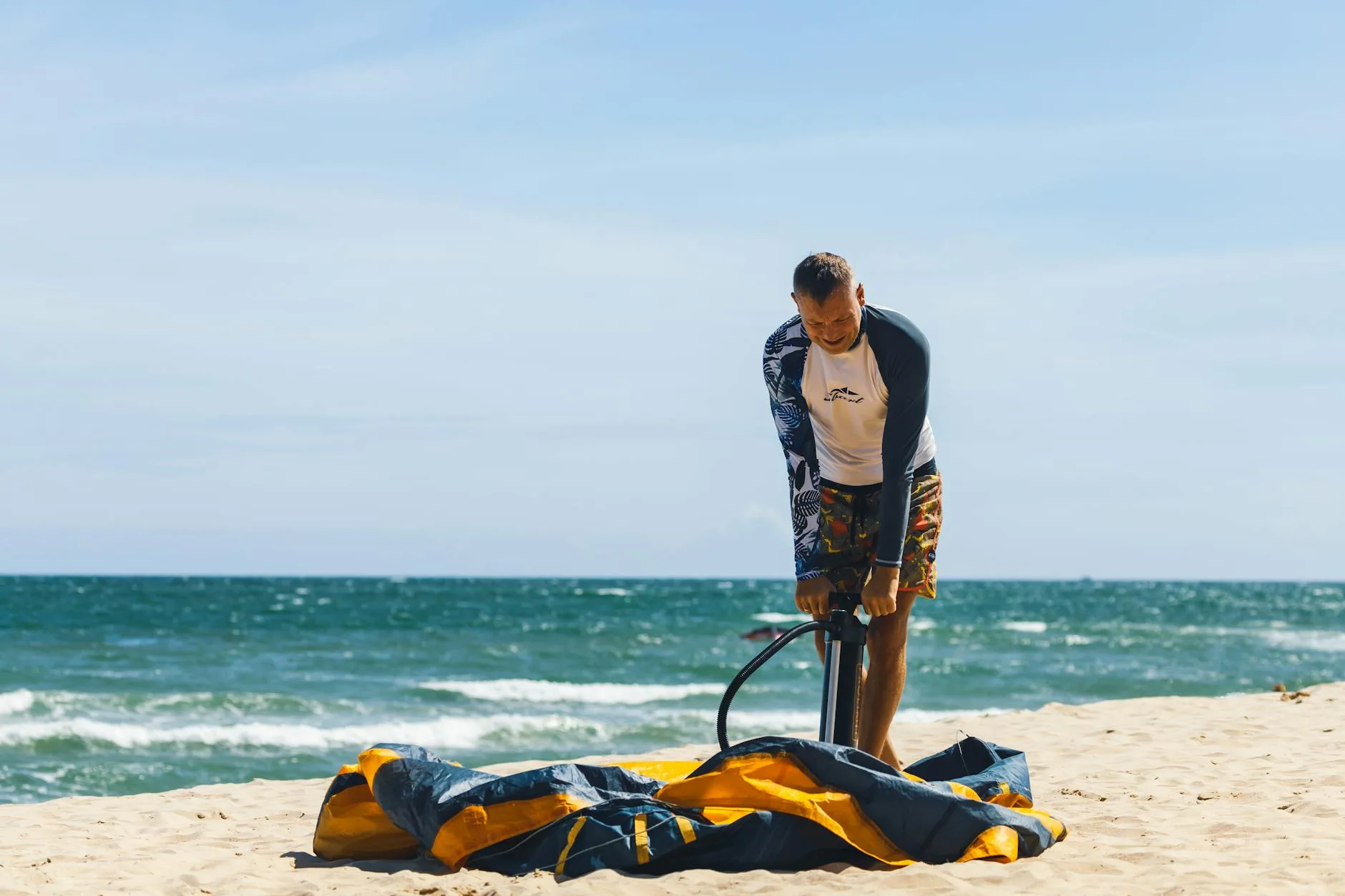 Colourful inflatable paddleboard on a sunny beach