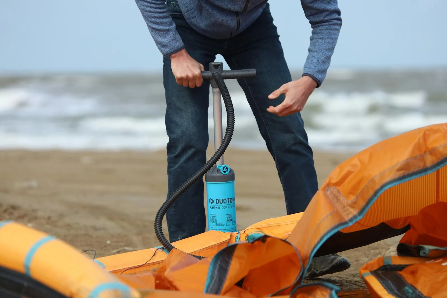Inflatable SUP board being set up at a beach