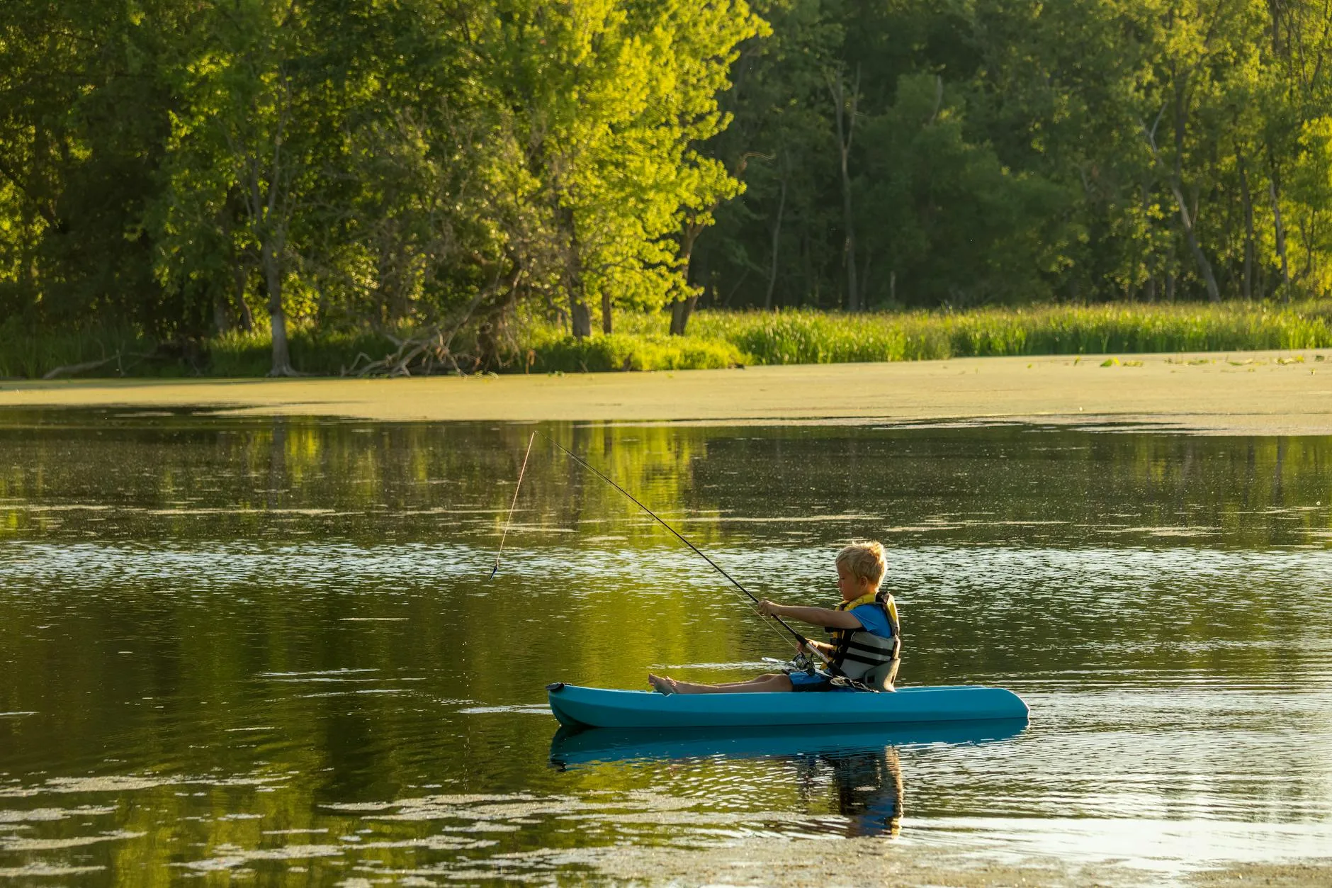 Angler fishing from a kayak on a river