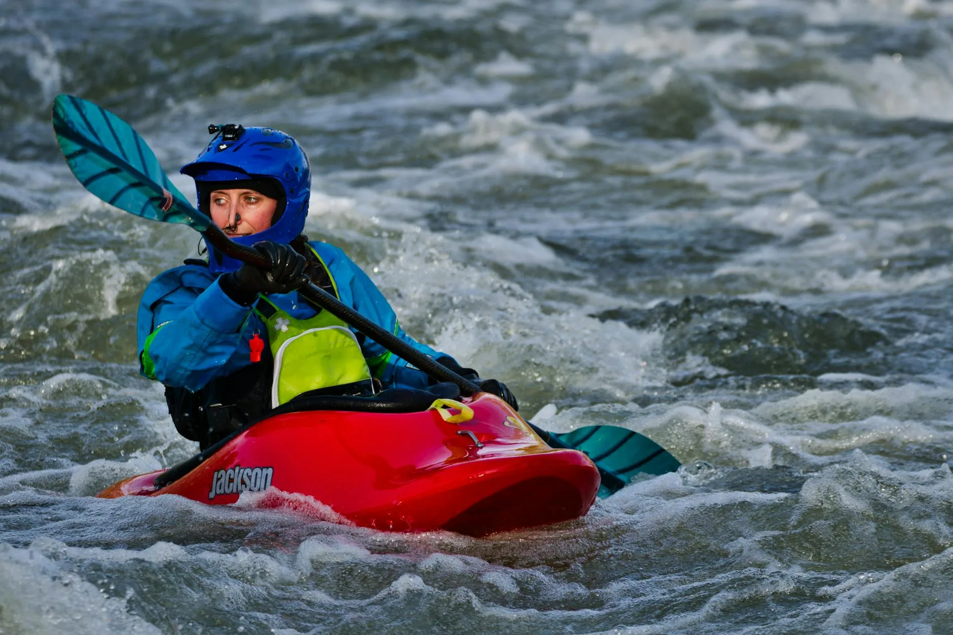 Kayaker demonstrating forward stroke paddling technique