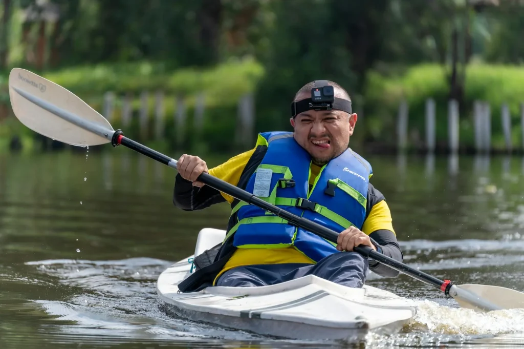 Kayaker paddling with proper stroke technique on calm water