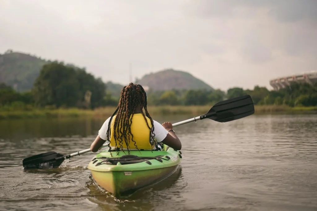 Kayaker holding a paddle correctly on calm water