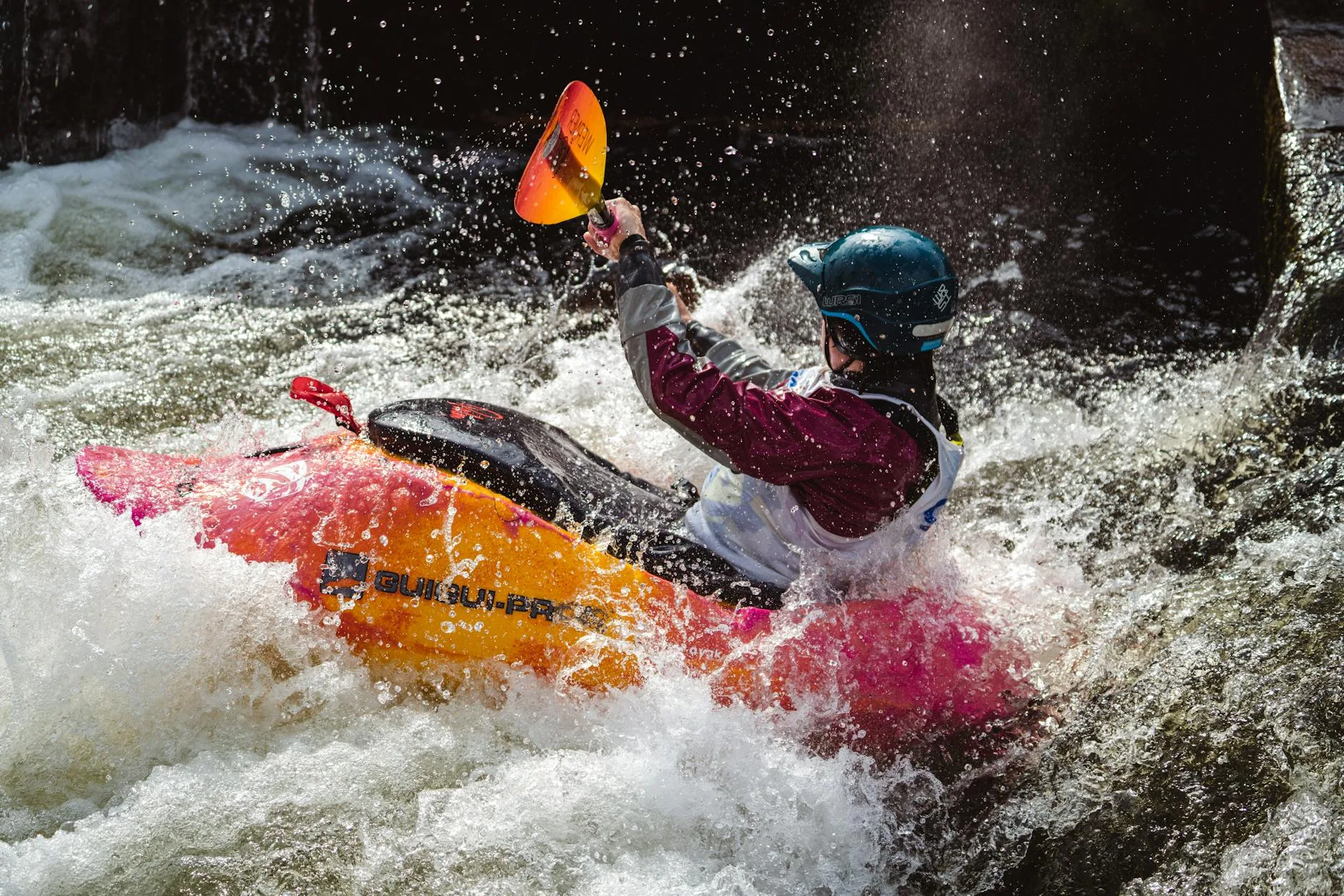 Kayaker performing a turning sweep stroke on a river