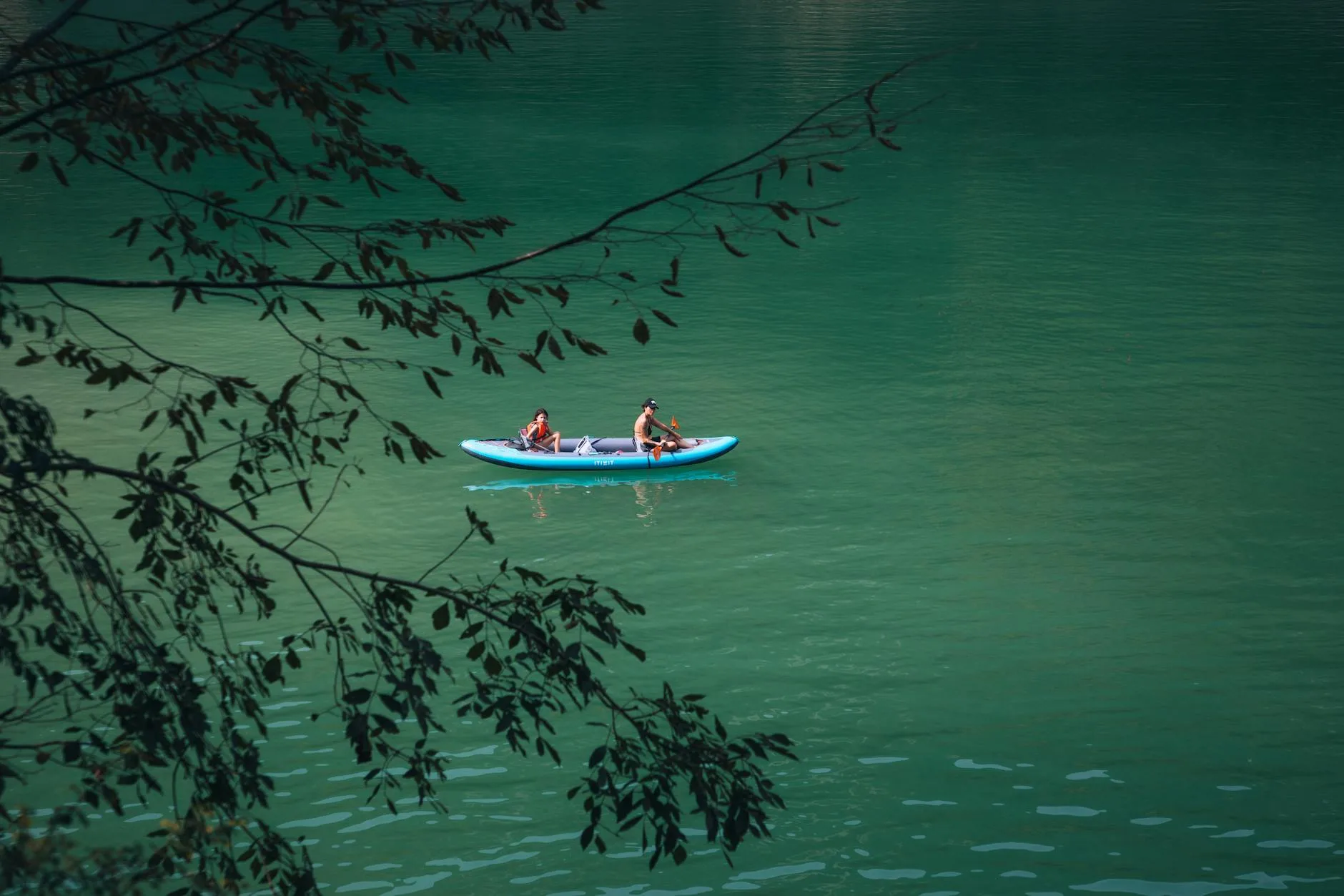 Kayaker touring on a calm lake surrounded by scenic nature