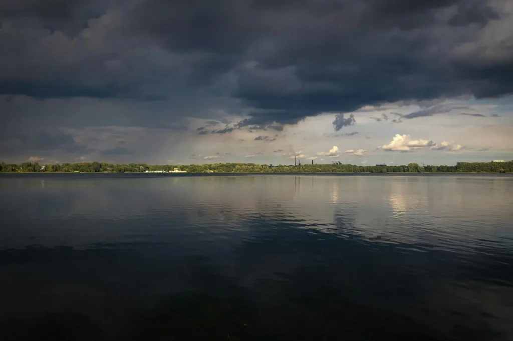 Paddler looking at stormy weather conditions from the shore