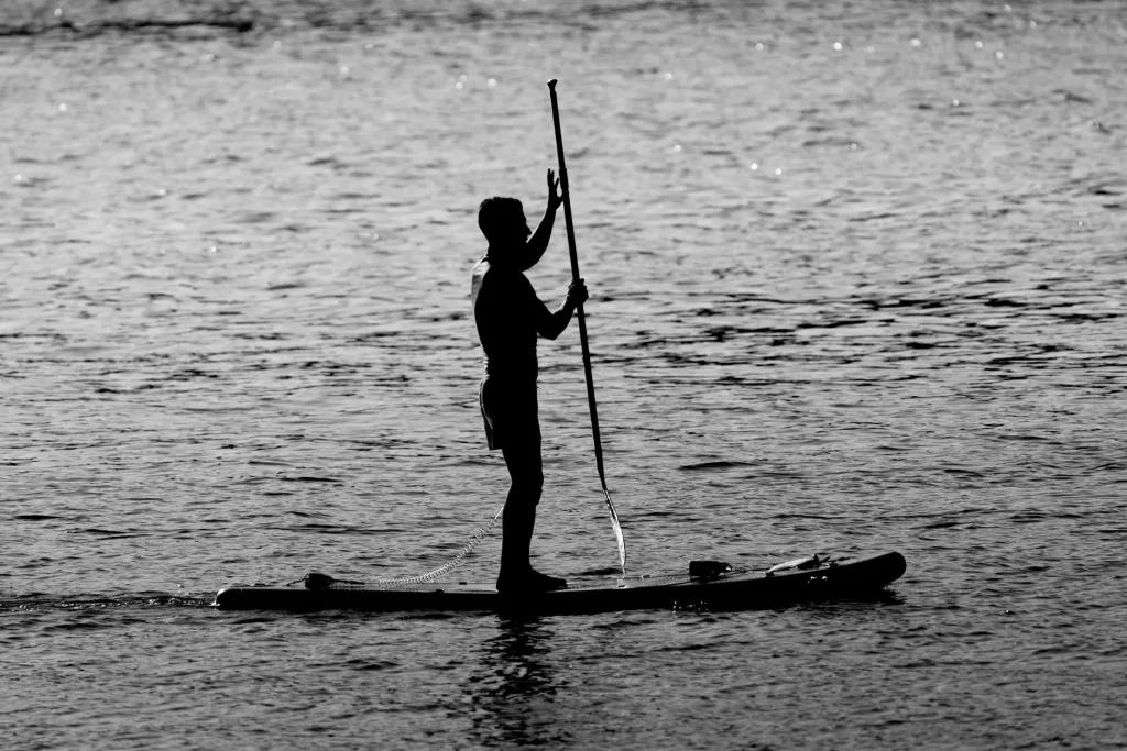 Person stand-up paddleboarding on a calm lake