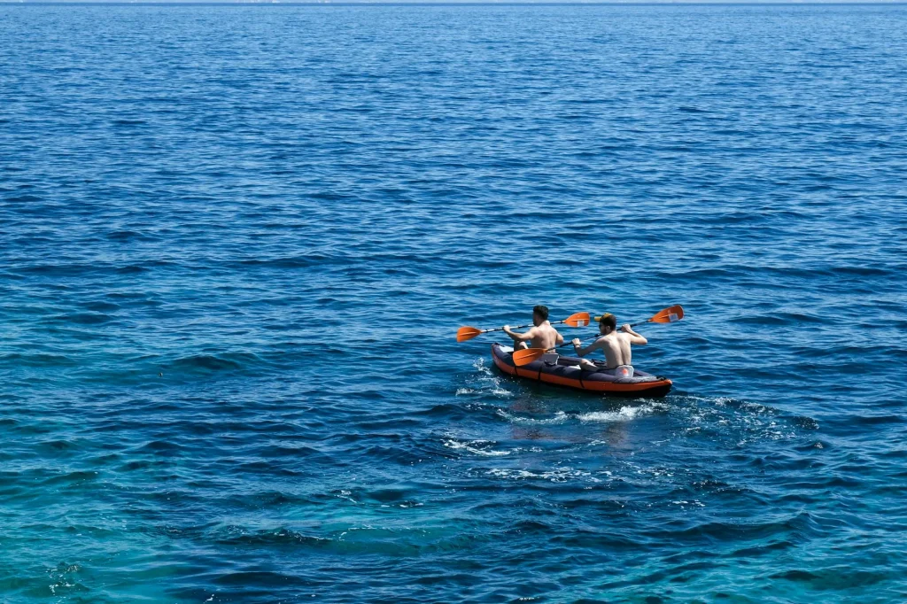 Two people kayaking together on a calm lake