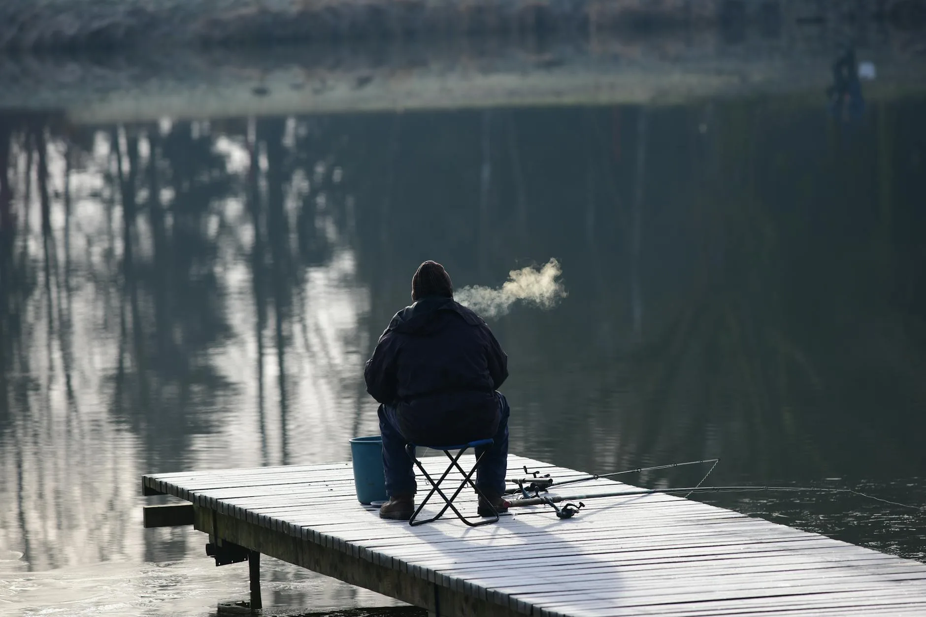 Angler fishing from a sit-on-top kayak on a calm lake