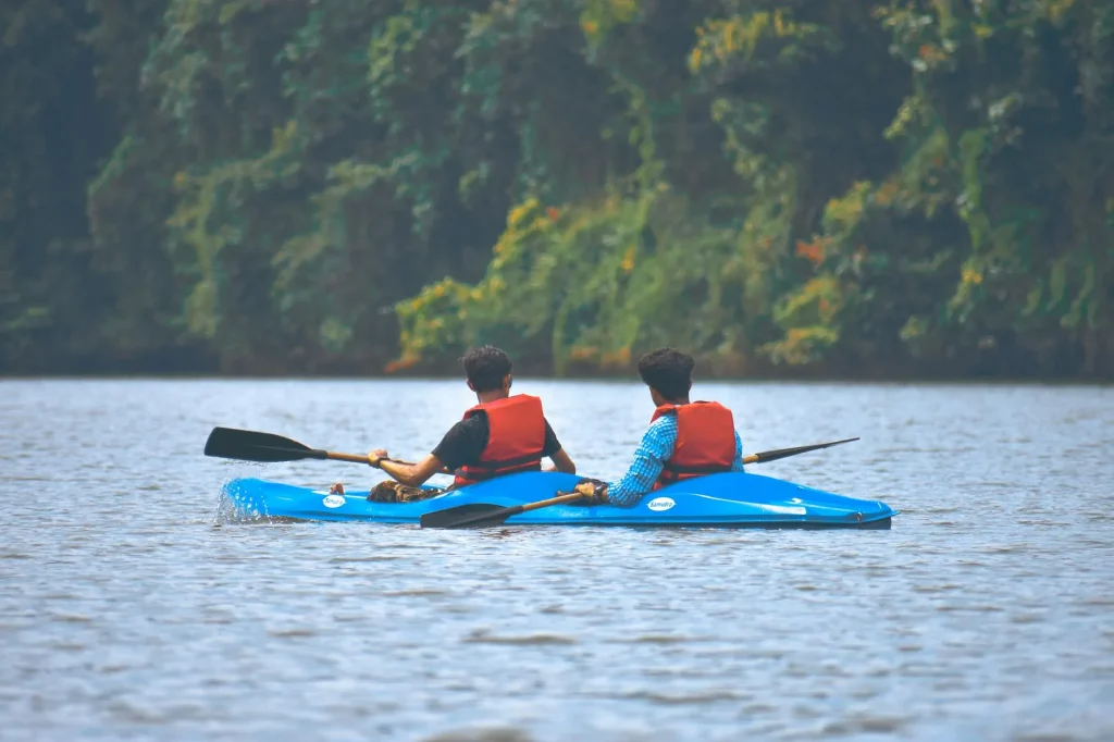 Kayaker paddling along a river surrounded by nature