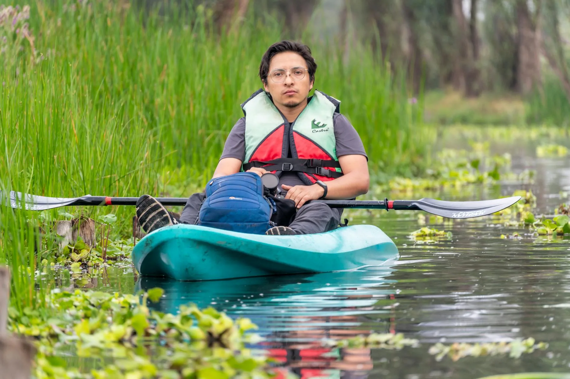 Person getting into a kayak at waters edge