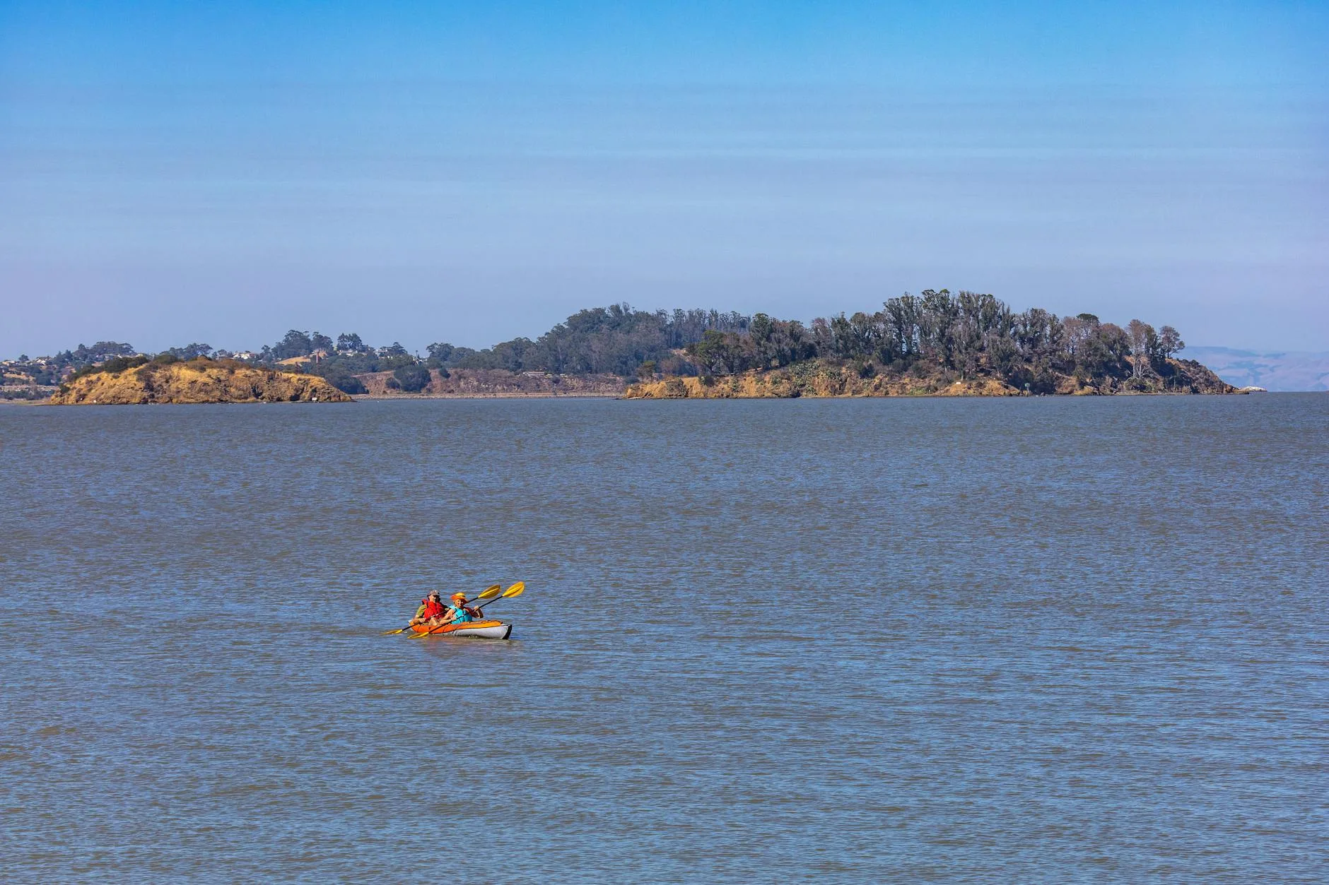 Sea kayaker paddling through coastal waves