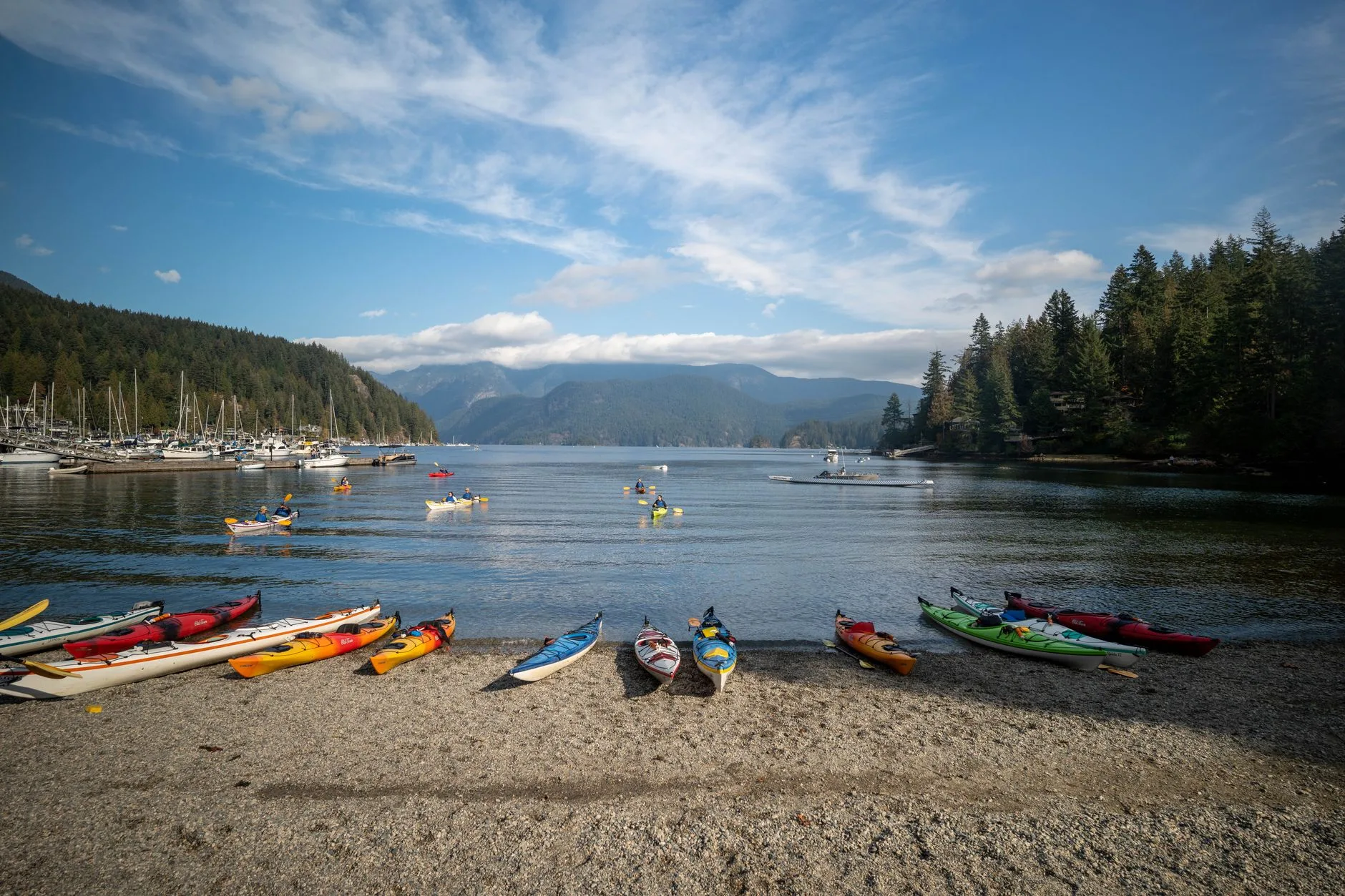 Kayaks on a lakeshore before checking load and trim