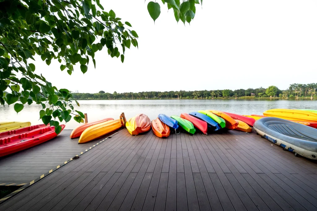 Kayaks lined up by calm water for a weight limit guide