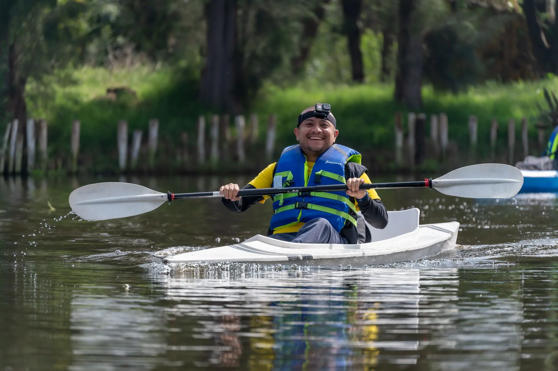 Kayaker wearing a buoyancy aid while paddling in windy water