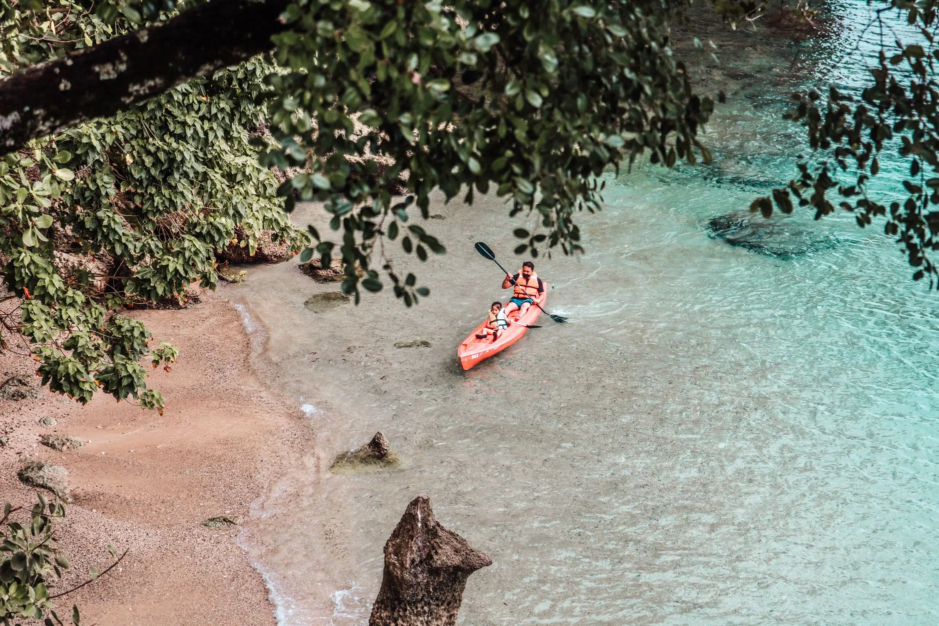 Sea kayaks pulled onto a beach after coastal paddling