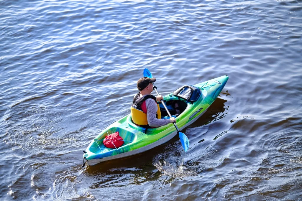 Kayaker using bracing strokes in rough water