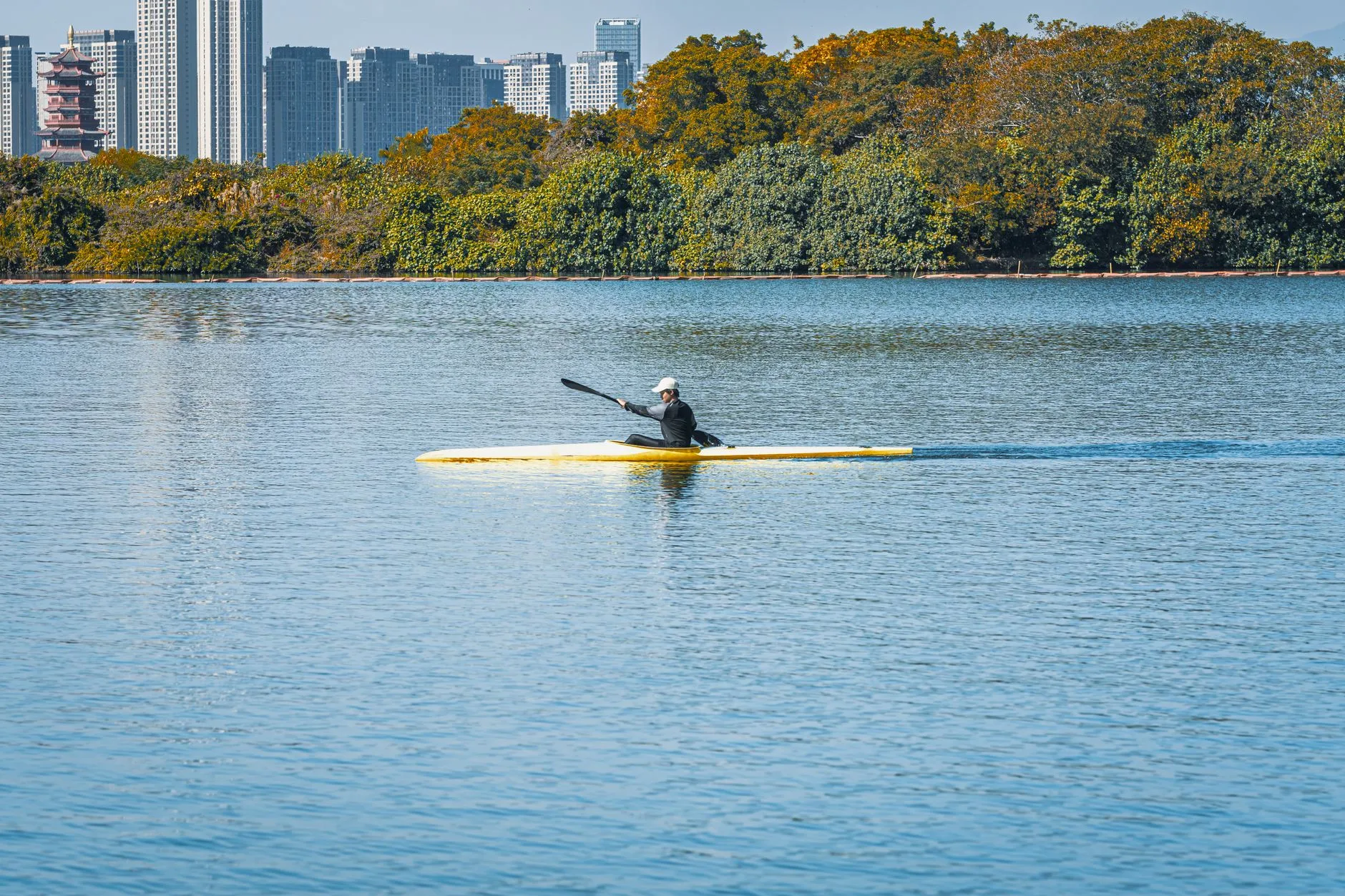 Hard shell kayak paddling on calm open water