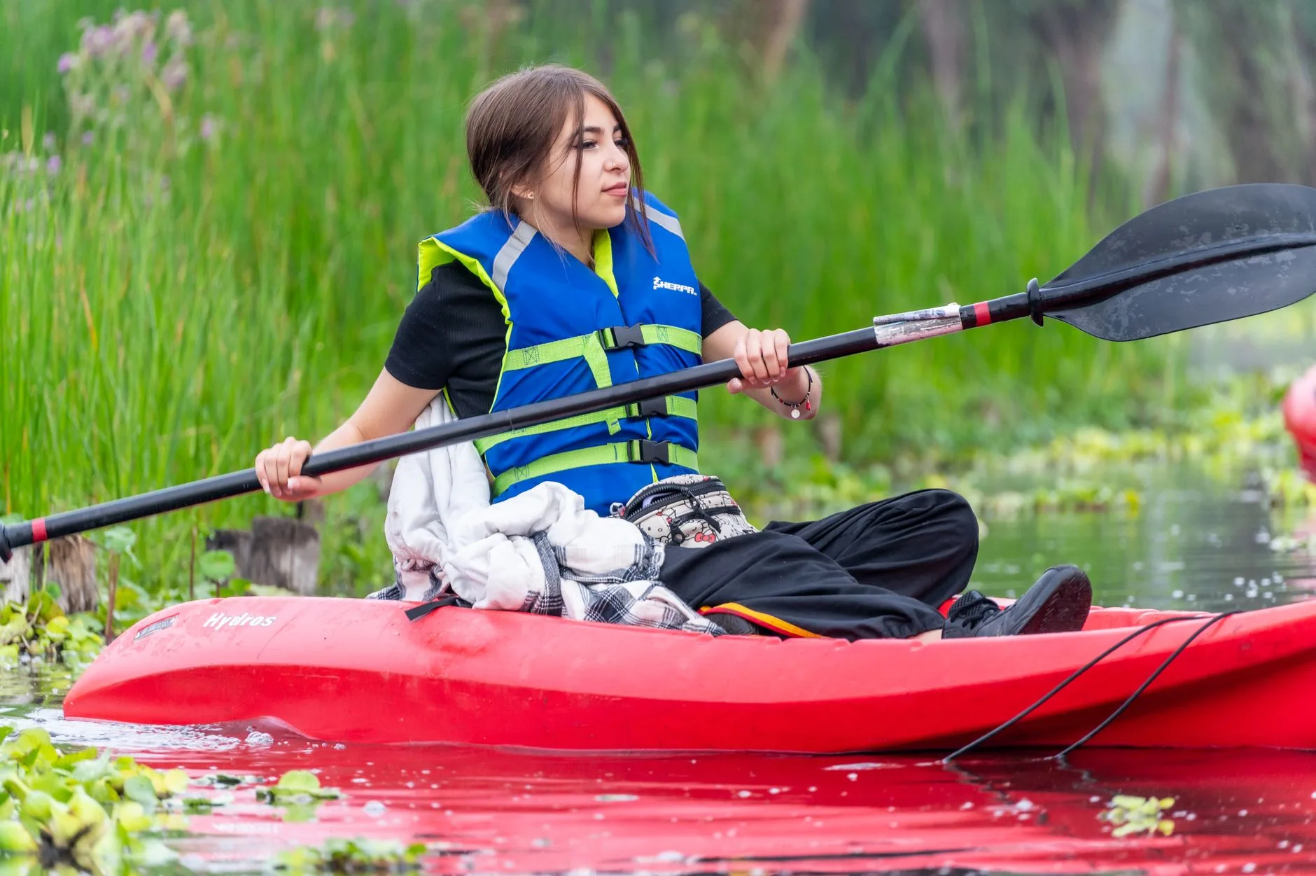 Kayaker seated with paddle and buoyancy aid before practice