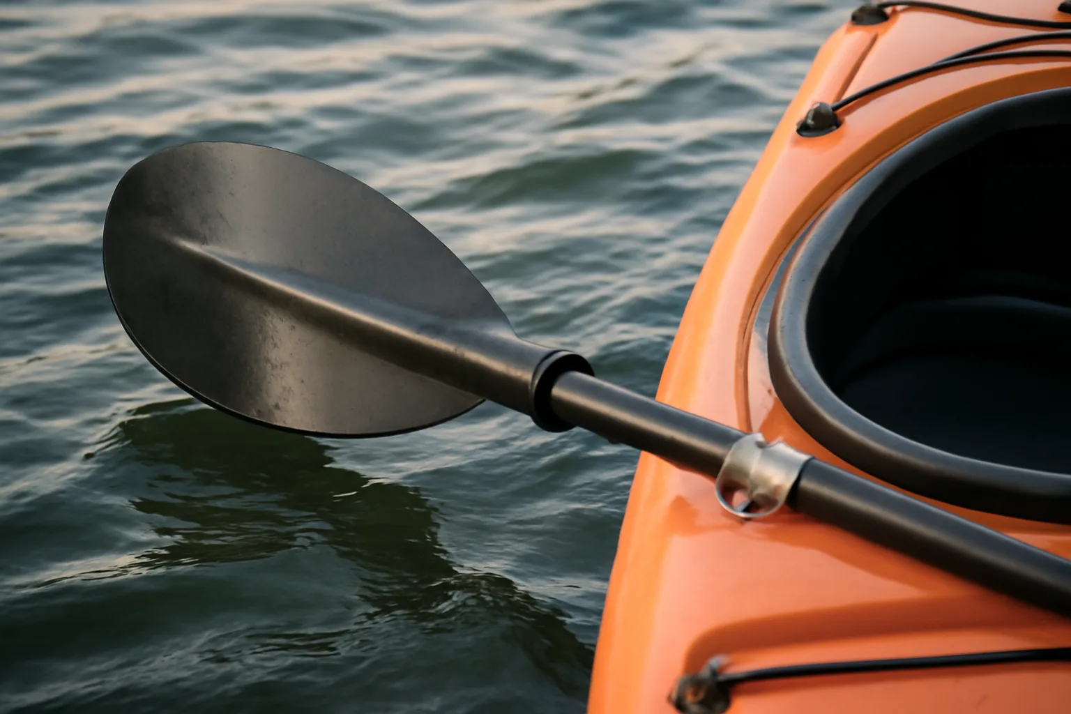 Kayak paddle blade flat on the water for a low brace