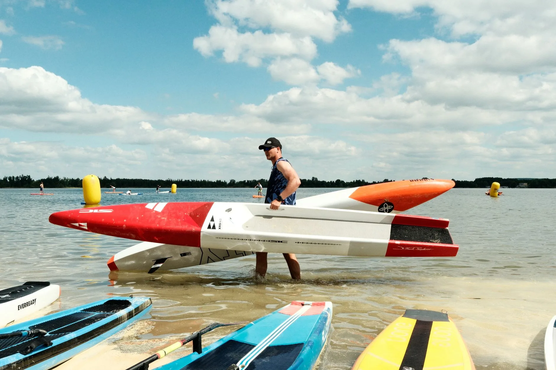 Long narrow racing paddleboard on water showing the speed-focused shape
