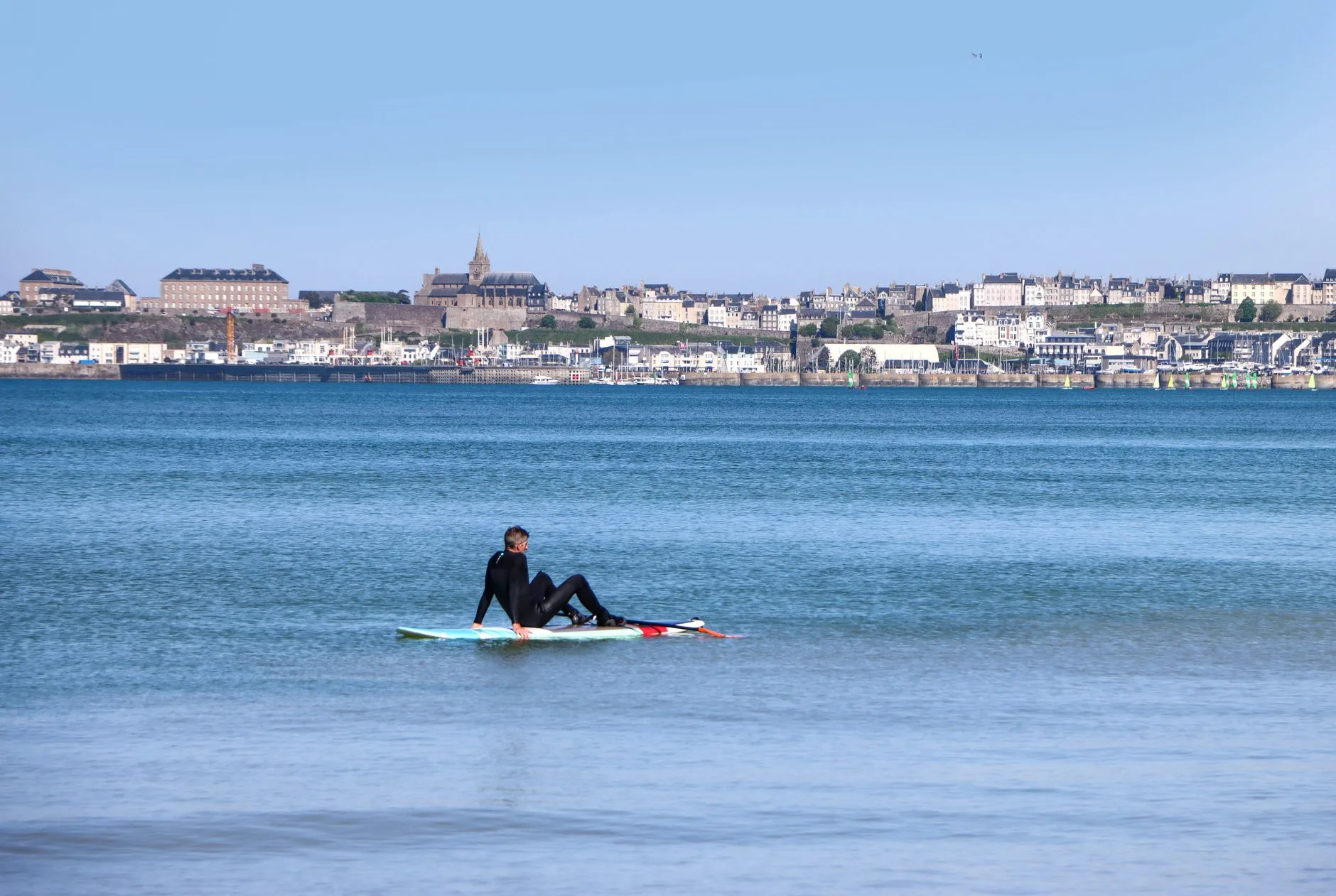 Paddleboarder dressed in neoprene for cold UK water
