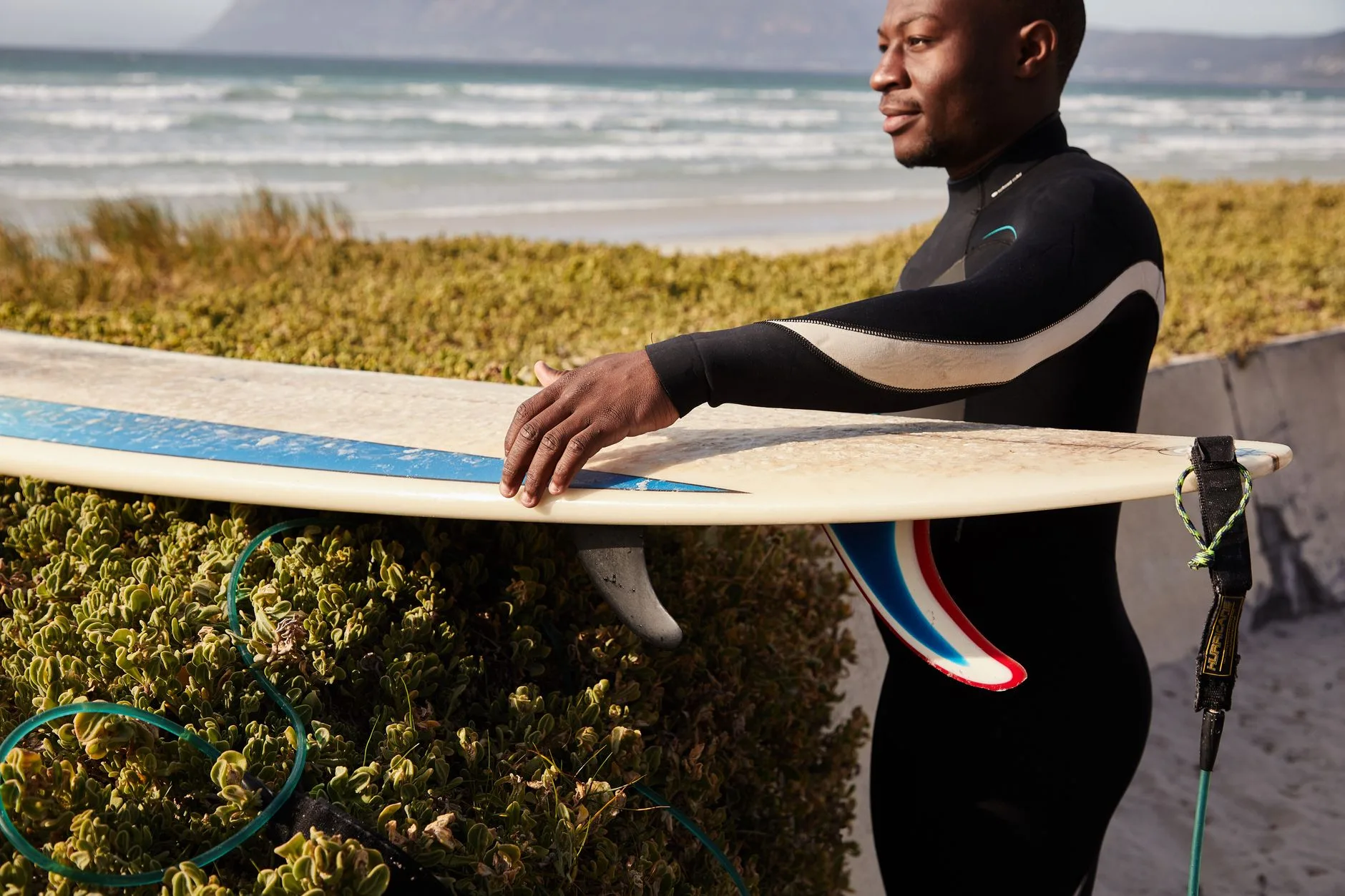 Paddler checking the fit of a full-length neoprene wetsuit