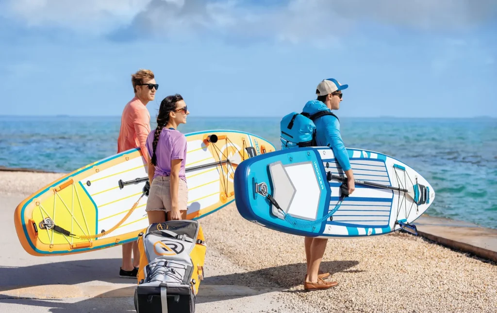 Kayak and paddleboard equipment prepared beside the water